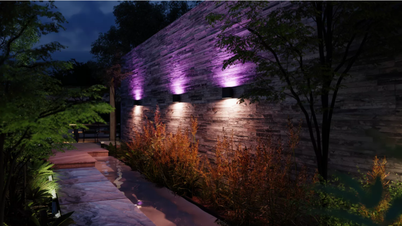 Philips Hue Dymera wall light creating dramatic light effects on a building facade