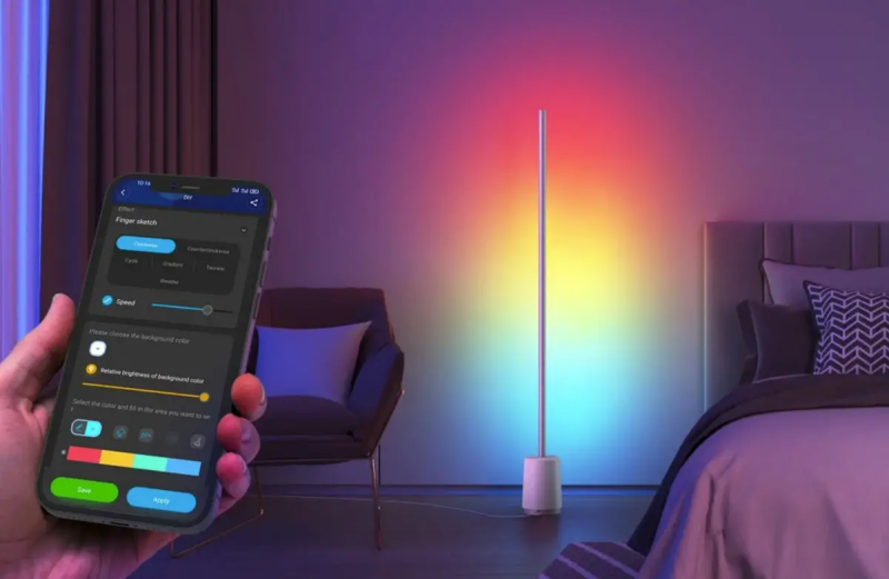Hand holding smartphone with Govee Home app displayed, with the lamp in the background.