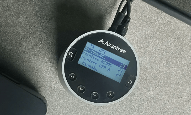 Top view of the Avantree Orbit Pro transmitter showcasing its display and functions