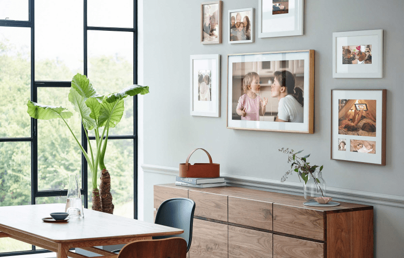 SAMSUNG The Frame TV seamlessly integrated with other frames in an office room