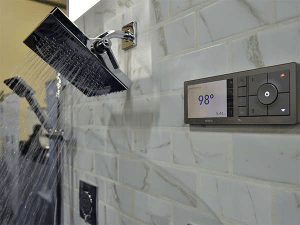 Features of the Moen Matte Black Smart Shower controller displayed on the LCD screen.