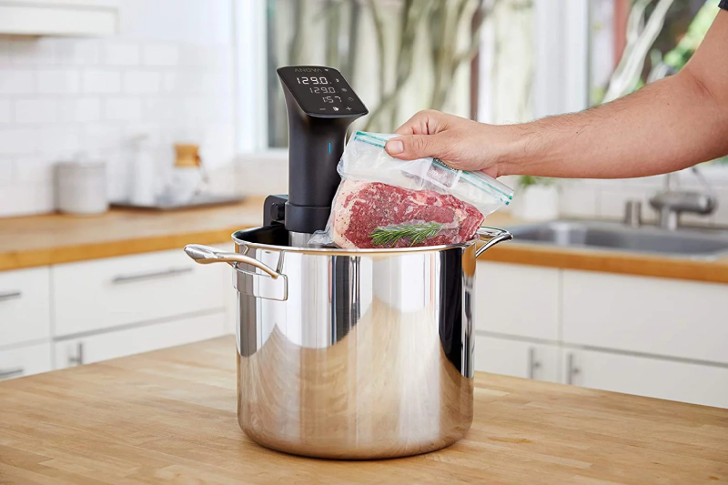 Anova Precision Cooker Pro cooking steak in a pan