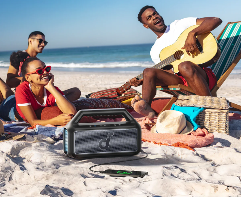 Outdoor speaker at the beach with friends enjoying music.