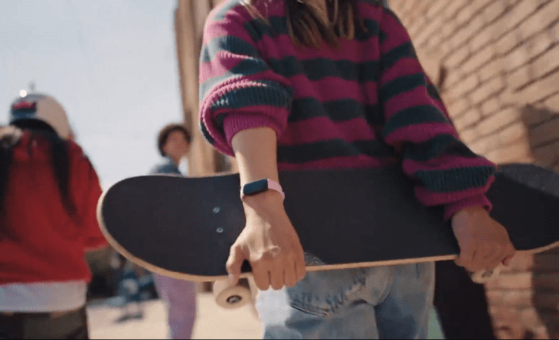 Fitbit Inspire 3 on a person skating with friends