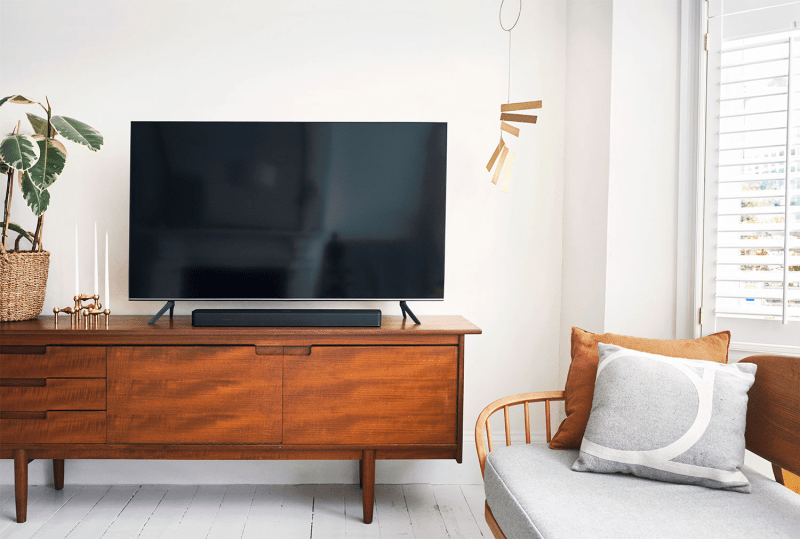 Bose TV Speaker positioned below a TV in a stylish living room