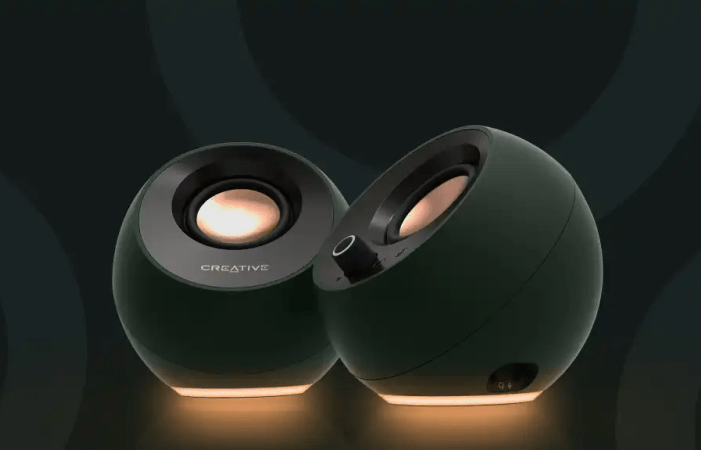 Creative Pebble Pro speakers glowing with golden light