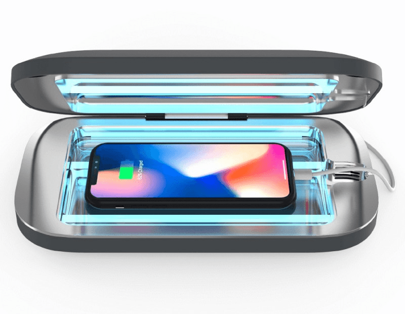 PhoneSoap 3 open with UV light on, sanitizing a smartphone