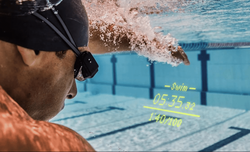 Swimmer wearing FORM Smart Swim 2 and viewing swim metrics.