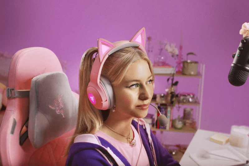 Woman wearing the Razer Kraken Kitty V2 headset while gaming and streaming content.