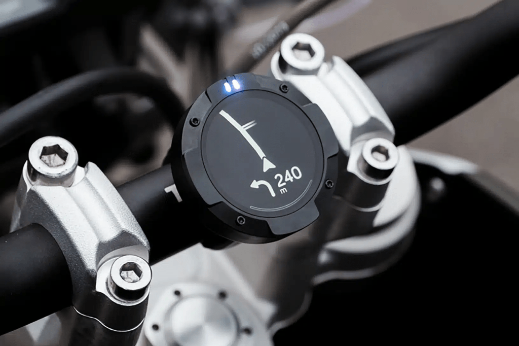 Beeline Moto device mounted on a motorcycle, displaying a route on its screen.