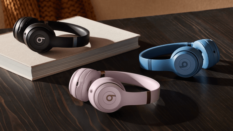 Three Beats Solo 4 headphones in blue, black, and pink colors displayed side by side.