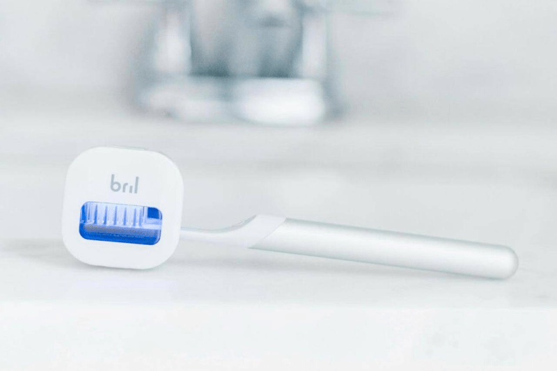 Close-up of Bril UV-C toothbrush sanitizer with the UV light activated.
