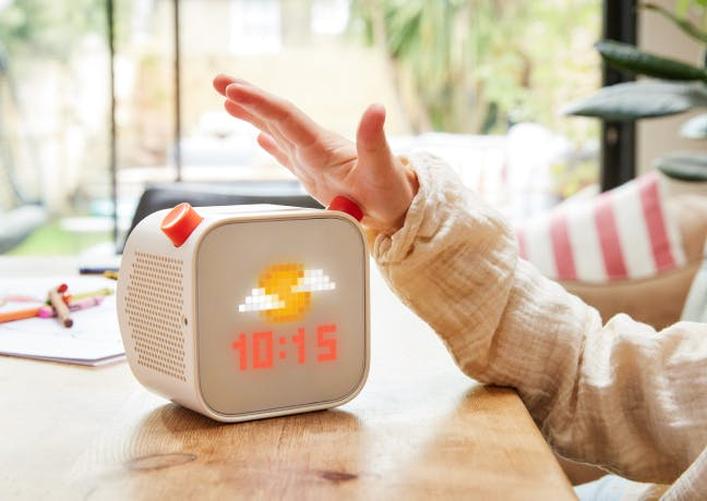 Yoto Player displaying the current time and weather on its screen.