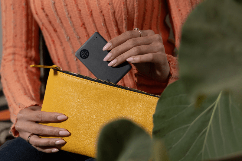 Model using Tile Slim to locate wallet in a busy urban setting.