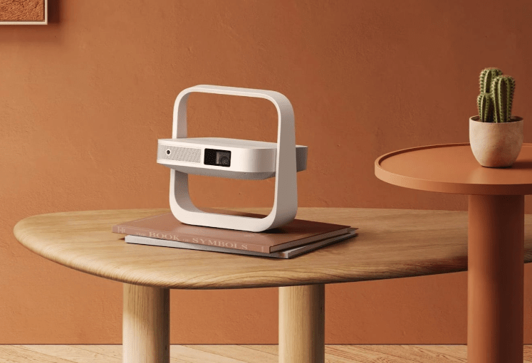 XGIMI Elfin Flip Portable Projector resting on a table with its adjustable stand folded