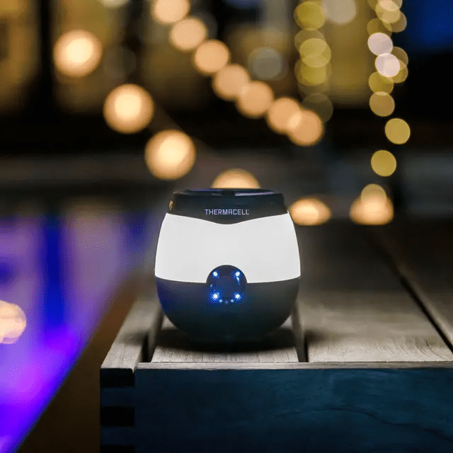 Thermacell E-Series Rechargeable Repeller resting on a patio table