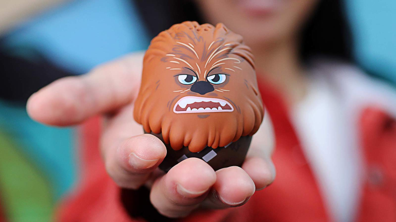 A person using the Bitty Boomers Chewbacca speaker as a selfie remote while connected to their smartphone.