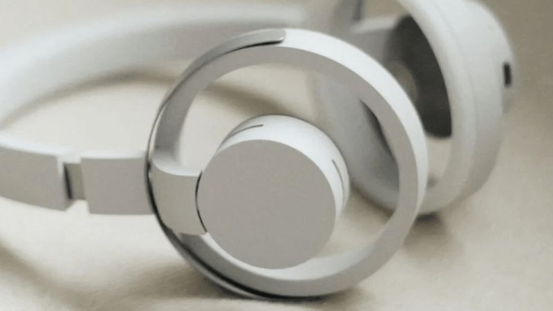 Closeup of nwm ONE Wireless Open-Ear Headphones, showcasing its dual-loop design and open-ear technology.