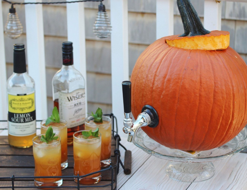 Pumpkin Tap Kit attached to a carved pumpkin, ready to serve drinks at a party.
