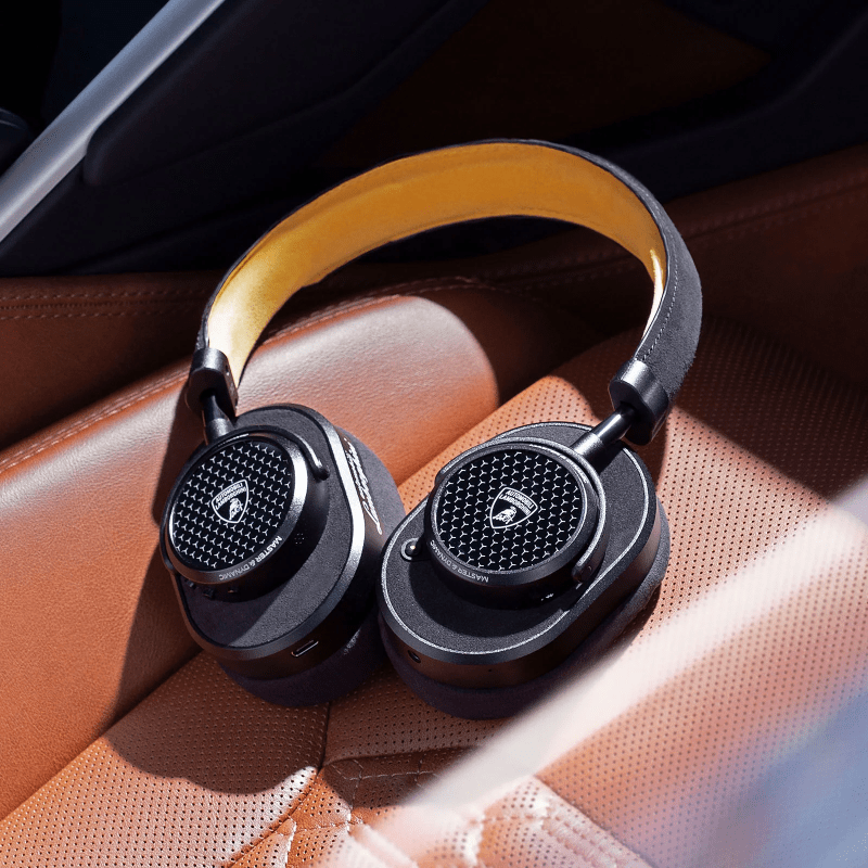 Closeup of the Master & Dynamic MW65 headphones in Gunmetal, highlighting the premium design with fine leather and anodized aluminum.