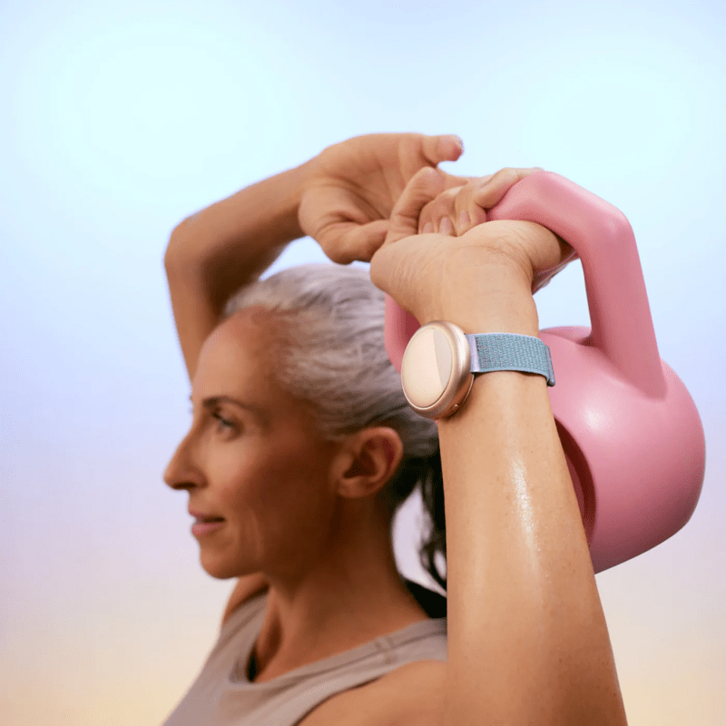 A woman exercising, wearing the Embr Wave 2 bracelet and enjoying its cooling function