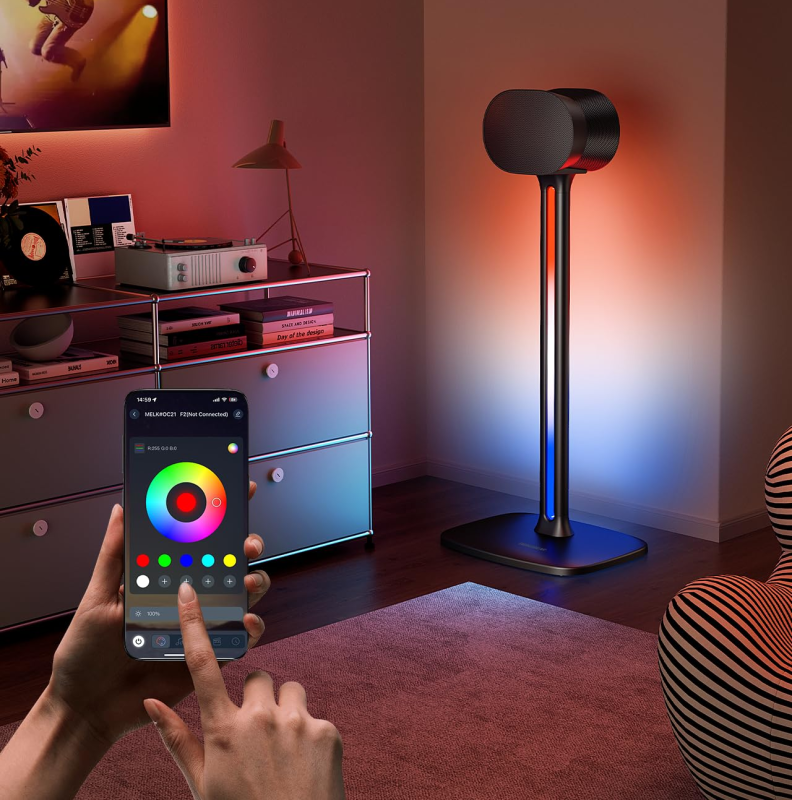 A user holding a smartphone displaying the lighting control app, selecting "Music Sync" mode, while the speaker stands in the background change color in response.